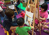 Canvas painting booth at family art event