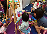 Canvas painting booth at family art event