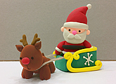 Christmas art and craft class or gift idea: clay modelling of a Santa Claus, his sleigh and a reindeer.