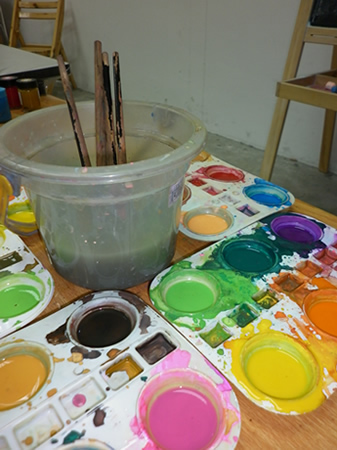 Paint and brushes used by art teacher for teaching in our children art class